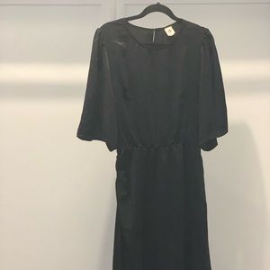 Black midi dress with sheen puffy shoulders (not too much). Great black dress